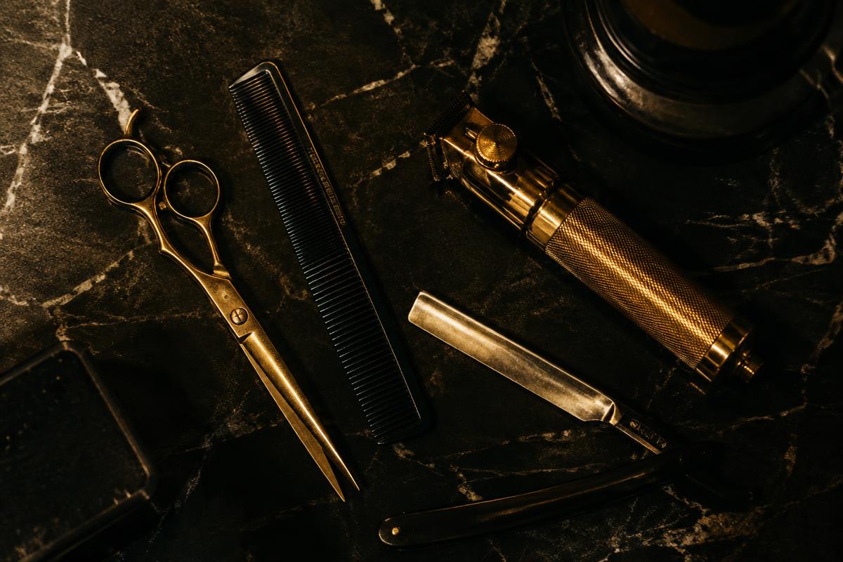 Barber tools laid out on dark marble